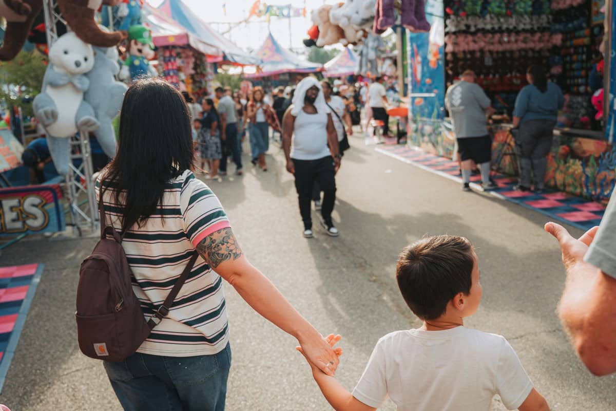 Family holding flexible Disneyland Paris open e-ticket pass at entrance gate