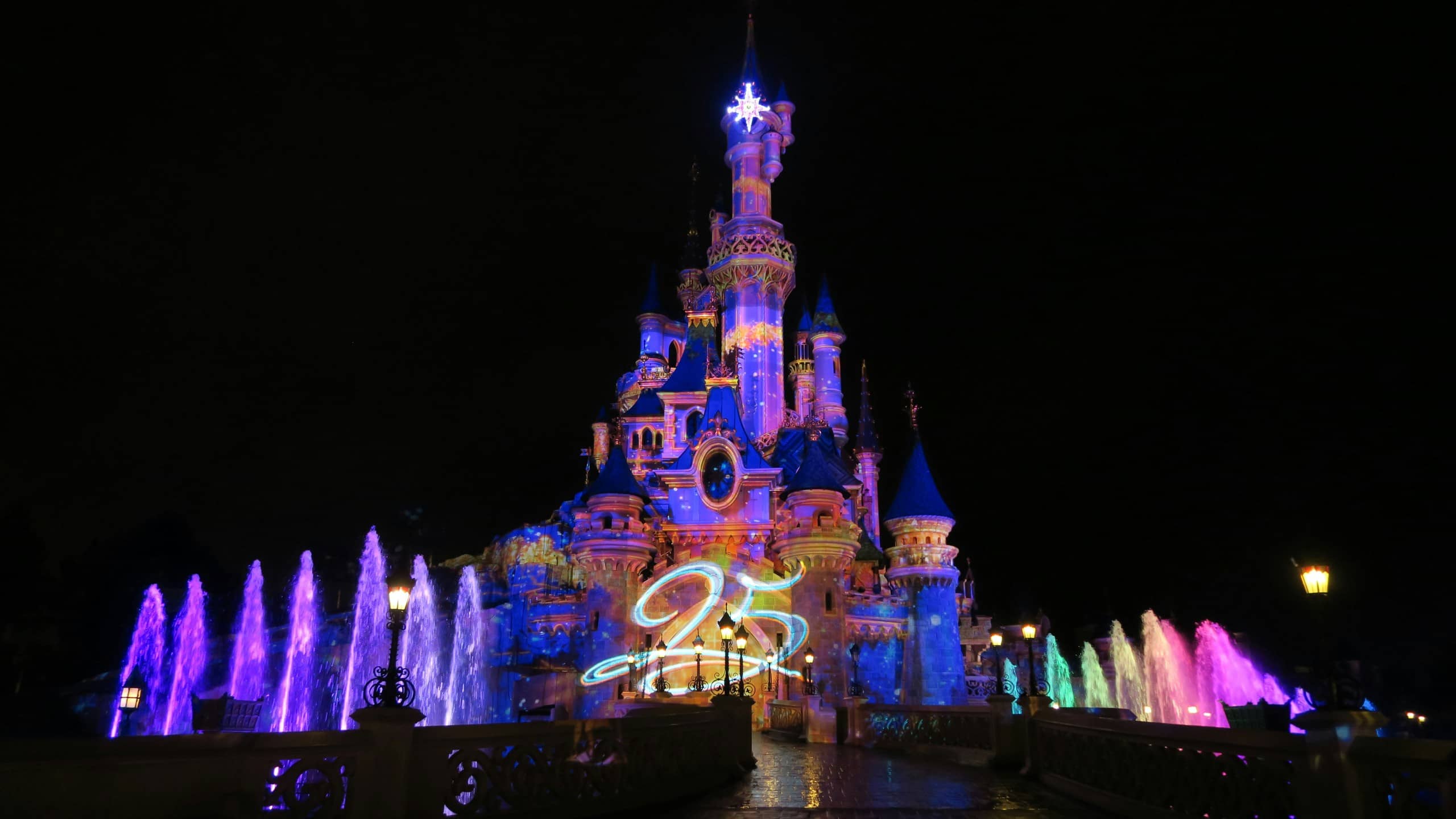 Fireworks display and light show over Sleeping Beauty Castle at night